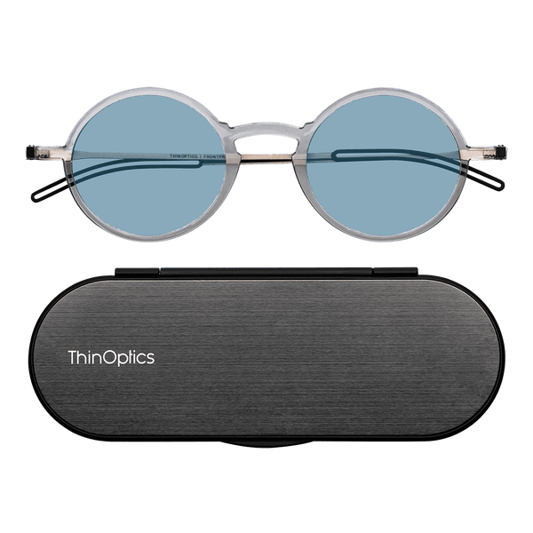 ThinOptics Clear framed Reading Glasses with Blue Light Blockers and a sleek black case: minimalist design with thin lenses. The compact, brushed metal case offers a modern, portable solution for individuals needing reading glasses.