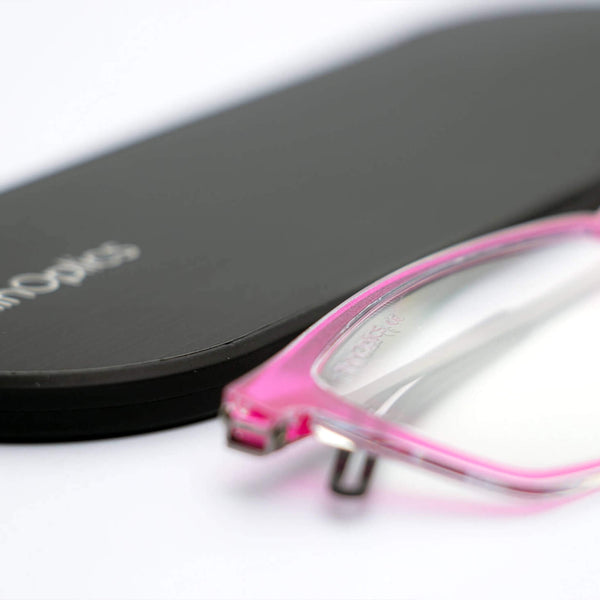 ThinOptics reading glasses and a sleek black case: minimalist design with thin lenses. The compact, brushed metal case offers a modern, portable solution for individuals needing reading glasses.