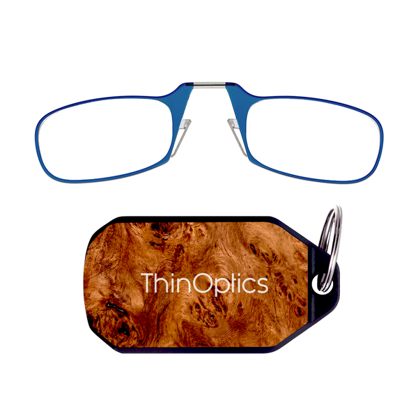 ThinOptics blue armless reading glasses above a burlwood keychain case