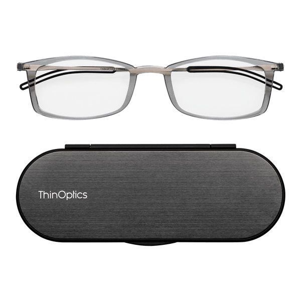 Silver ThinOptics reading glasses rest on a sleek, grey carrying case.