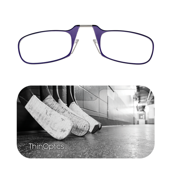 Purple ThinOptics reading glasses rest above a black and white image of hockey sticks lined up in a locker room.