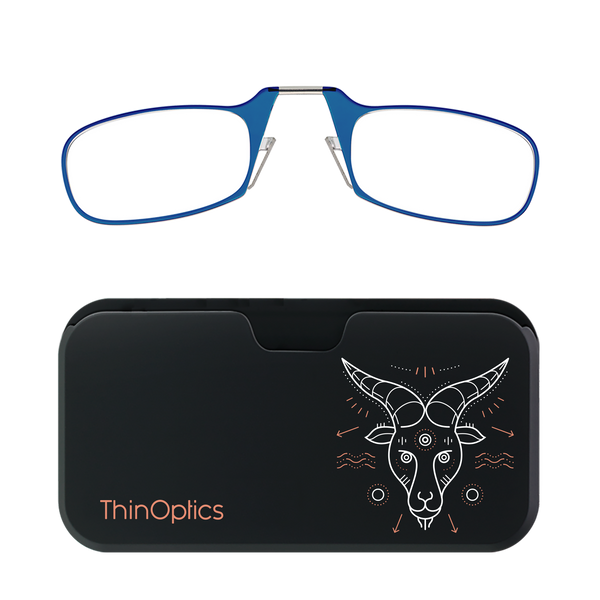 Blue ThinOptics reading glasses rest on a black carrying case decorated with a stylized white and copper goat head.