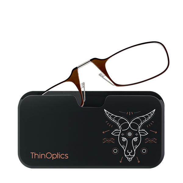 ThinOptics brown reading glasses rest on a sleek, black carrying case decorated with a stylized white ram design.