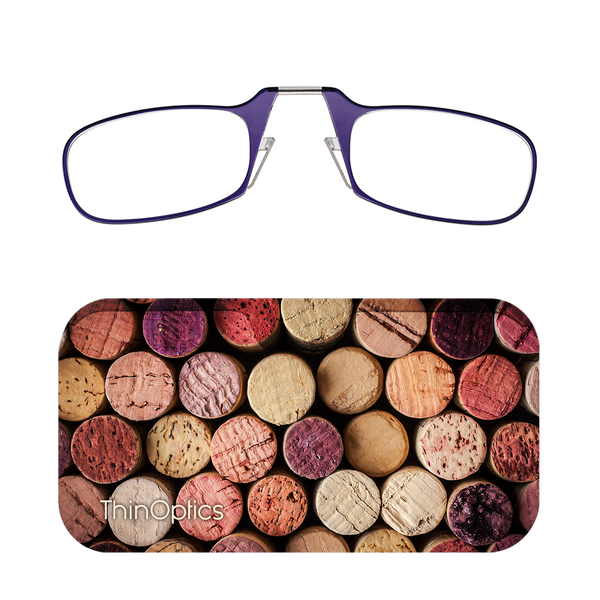 ThinOptics purple reading glasses rest on a background of assorted wine corks.