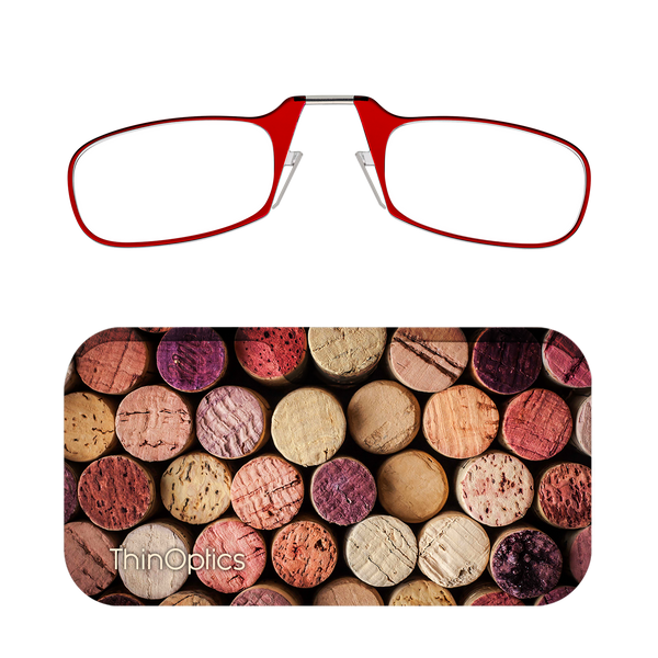 Red ThinOptics reading glasses rest on a background of assorted wine corks.