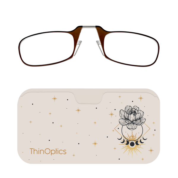Brown ThinOptics reading glasses rest unfolded on their sleek, celestial-themed carrying case.