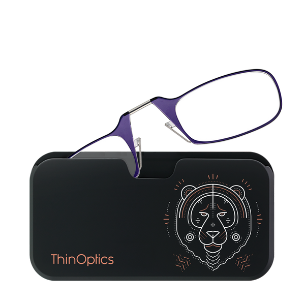 Purple ThinOptics reading glasses rest folded on their sleek black case featuring a geometric tiger design.