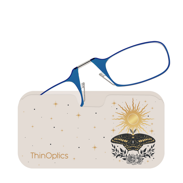 Blue ThinOptics reading glasses rest folded atop a stylish beige case featuring a celestial design of a sun, butterfly, and stars.