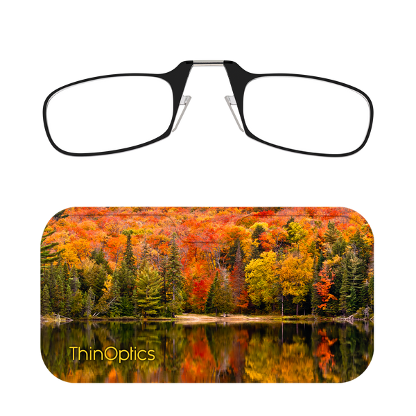 ThinOptics reading glasses enhance a vibrant autumn forest reflected in a still lake.