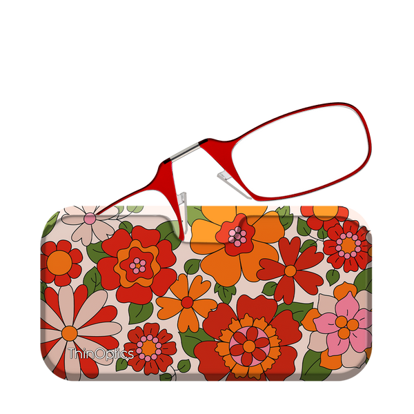 Red ThinOptics reading glasses rest unfolded on their floral patterned case.