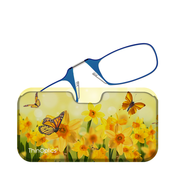 Blue reading glasses folded and resting on top of their matching floral case featuring yellow daffodils and monarch butterflies.