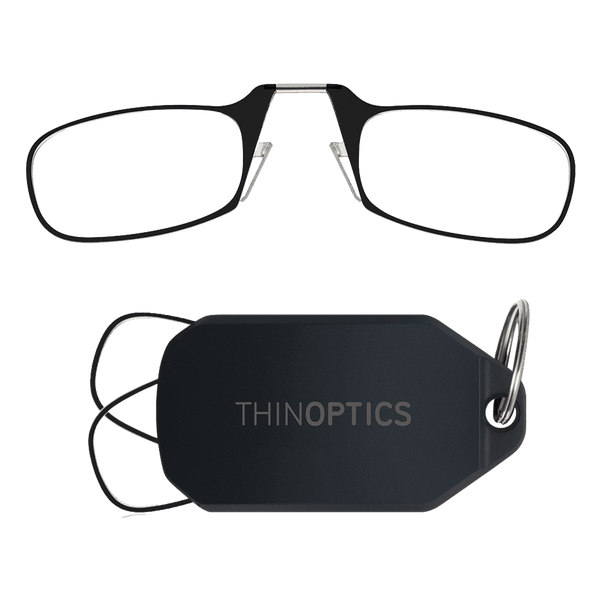 ThinOptics reading glasses folded next to their compact keychain case.