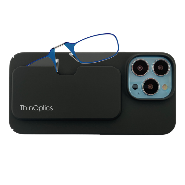 ThinOptics blue reading glasses are shown folded and tucked into their sleek black phone case attached to a smartphone.
