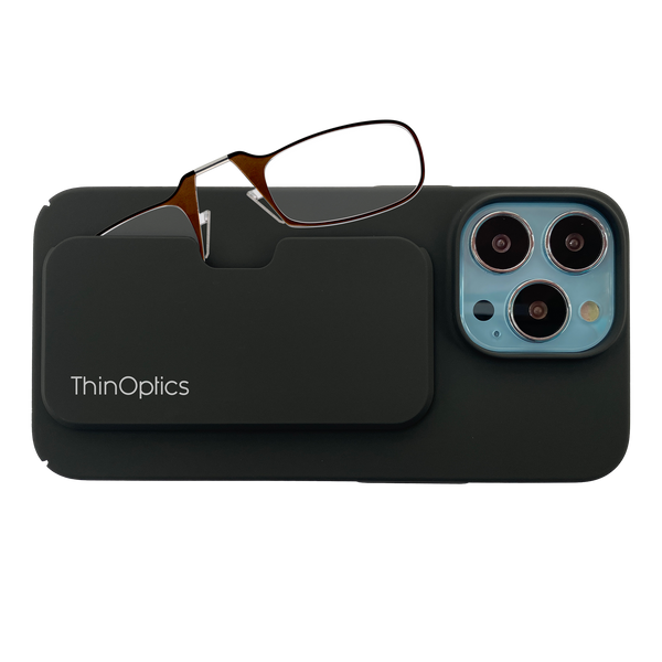 ThinOptics reading glasses rest on a slim black phone case attached to the back of a smartphone.