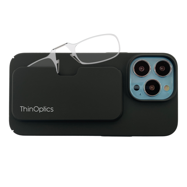 ThinOptics reading glasses rest on a black phone case, showcasing the product's portability and slim design.