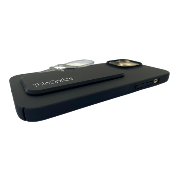 A black ThinOptics phone case holds a pair of ThinOptics reading glasses securely on the back of a smartphone.