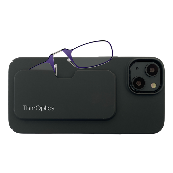 ThinOptics purple reading glasses rest on a black phone case, showcasing the product's slim design and portability.