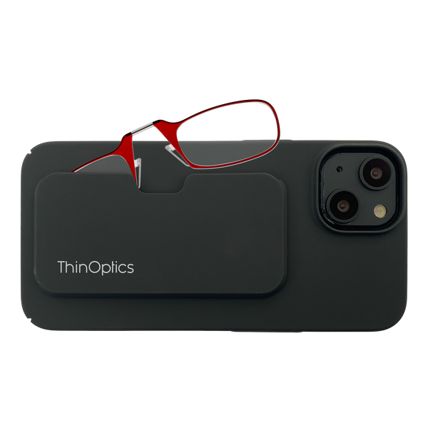 Red ThinOptics reading glasses rest securely in their slim black case attached to the back of a phone.