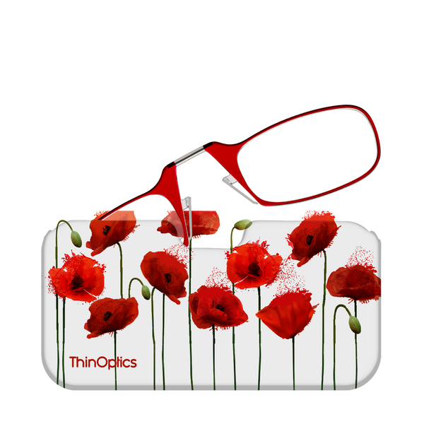 Red reading glasses with a poppy flower design rest on a white case.