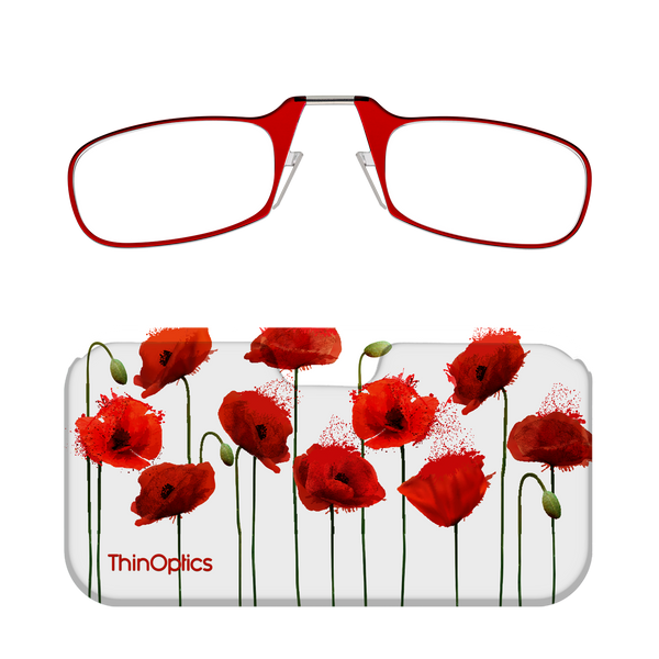 Red reading glasses with spring hinges folded atop a white case adorned with a vibrant poppy flower design.