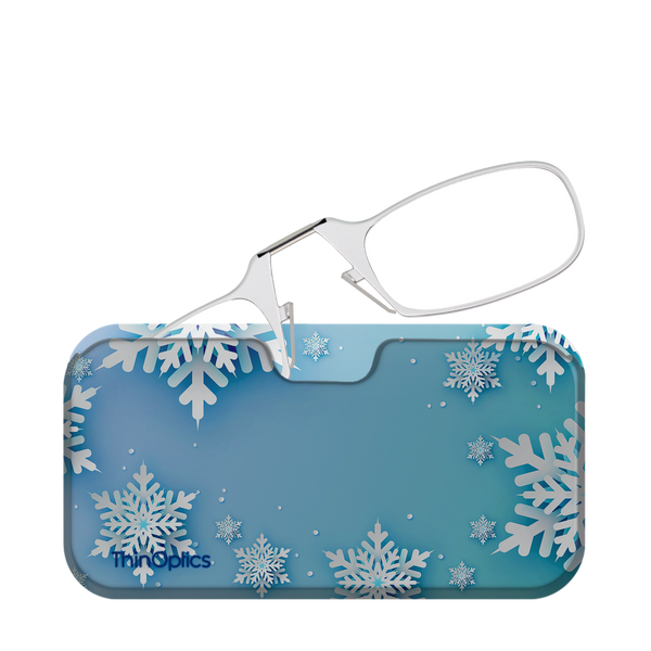 Silver ThinOptics reading glasses rest on a blue snowflake-patterned case.
