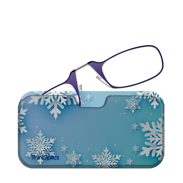 Purple ThinOptics reading glasses rest on a blue snowflake-patterned case.
