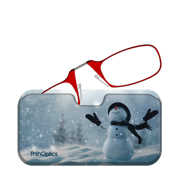 Red ThinOptics reading glasses rest on a snowy winter-themed case featuring a snowman.