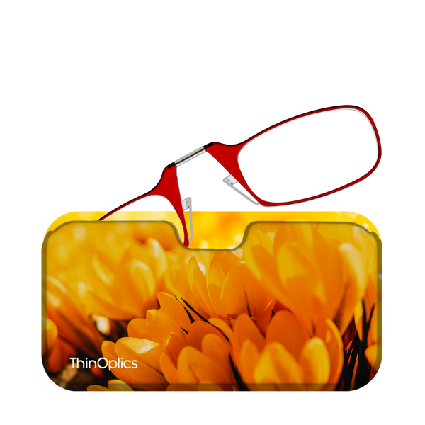 Red ThinOptics reading glasses rest on a vibrant yellow crocus flower background.