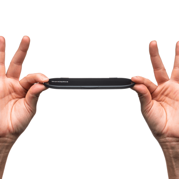 ThinOptics Clear Reading Glasses with Blue Light Blockers and a sleek black case: minimalist design with thin lenses. The compact, brushed metal case offers a modern, portable solution for individuals needing reading glasses.