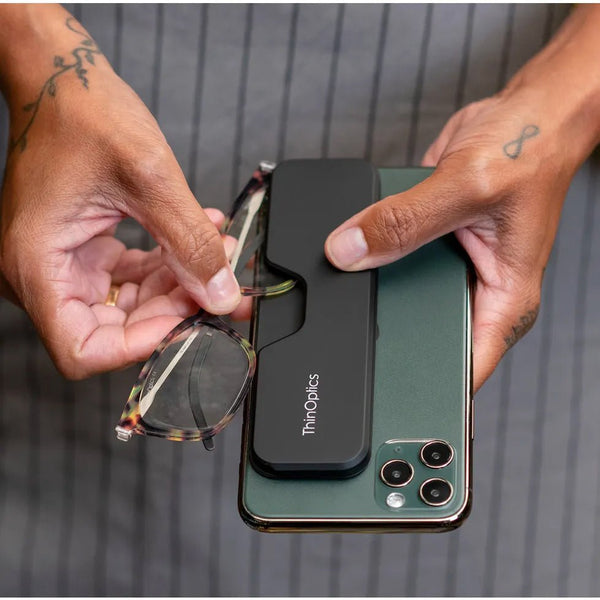ThinOptics Tortoise Frame Connect Reading Glasses and a sleek black Connect case: minimalist design with thin lenses. The compact, polycarbonate case offers a modern, portable solution for individuals needing reading glasses.