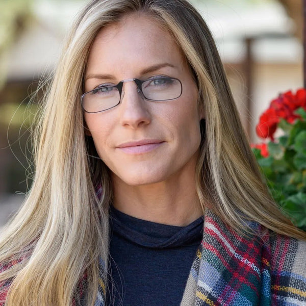Woman with long blonde hair wears rectangular eyeglasses with a thin frame.