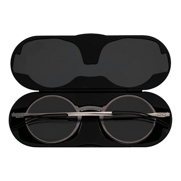 ThinOptics reading glasses and a sleek black case: minimalist design with thin and round lenses. The compact, brushed metal case offers a modern, portable solution for individuals needing reading glasses.