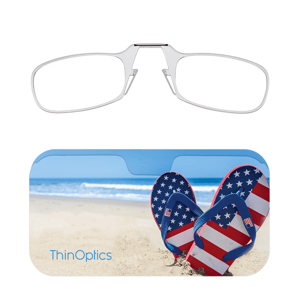 Silver ThinOptics reading glasses folded atop a beach-themed case featuring American flag flip-flops.