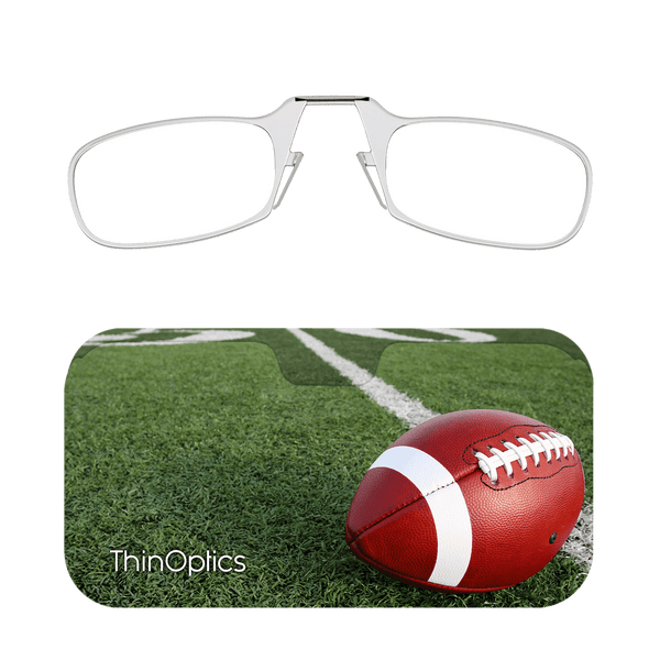 Silver ThinOptics reading glasses rest on a football-themed carrying case displaying a football on a vibrant green field.