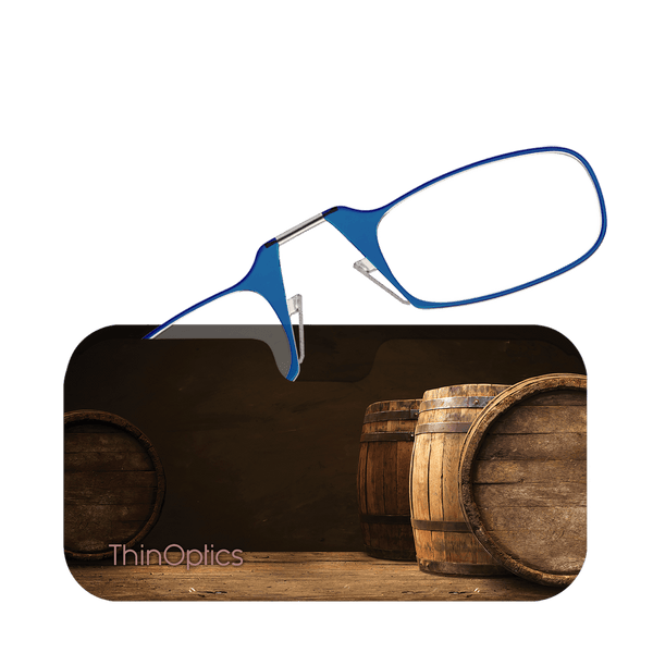 Blue ThinOptics reading glasses rest on a slim case featuring a rustic image of wooden barrels.