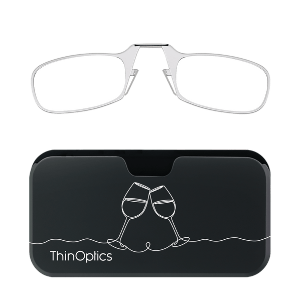 Silver ThinOptics reading glasses fold into their compact black case featuring a minimalist line drawing of toasting wine glasses.