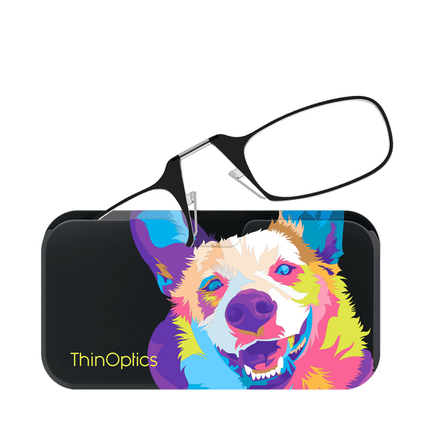 ThinOptics reading glasses rest on a colorful case featuring a vibrant, pop-art style dog portrait.