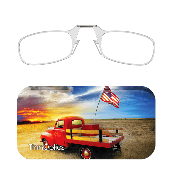 Silver ThinOptics reading glasses fold into a compact case featuring a classic red pickup truck and American flag at sunset.