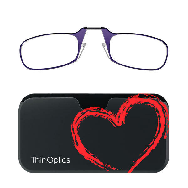 Purple ThinOptics reading glasses folded atop a black case featuring a red painted heart design.