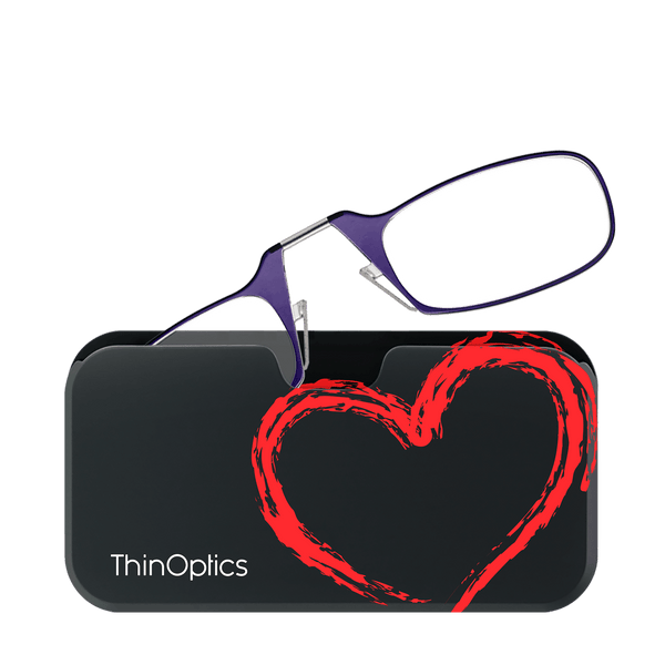 Purple ThinOptics reading glasses rest on a black case featuring a bold red heart design.