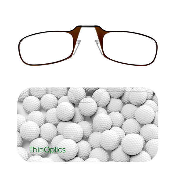 Brown ThinOptics reading glasses rest on a case displaying a close-up image of white golf balls.