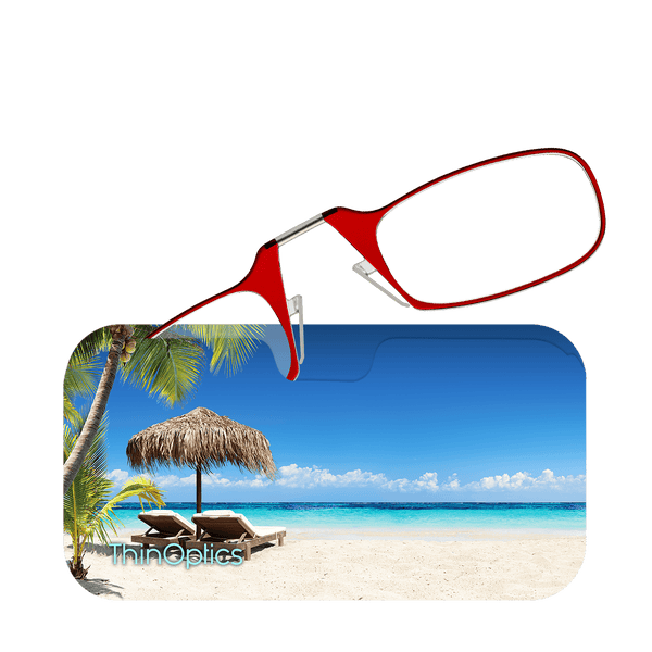 Red reading glasses hover over a tropical beach scene. The beach has white sand, palm trees, a thatched umbrella, and lounge chairs.