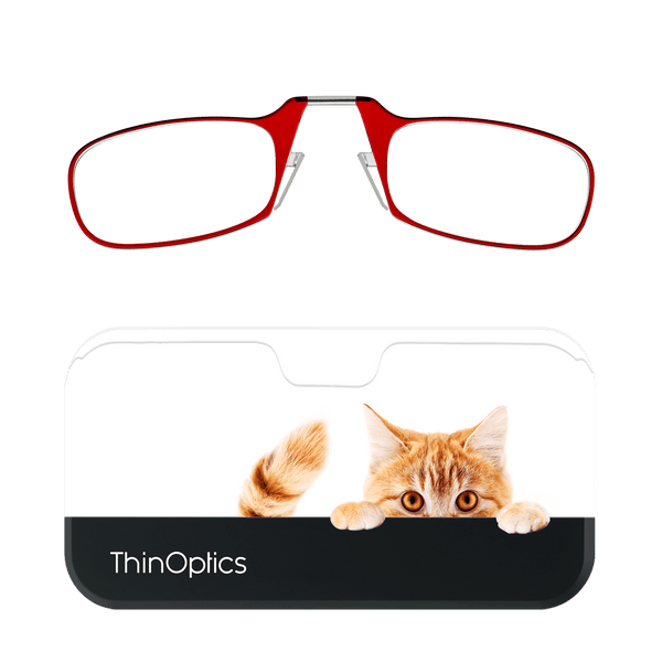Red reading glasses folded above a ThinOptics case featuring a ginger cat peering over the edge.