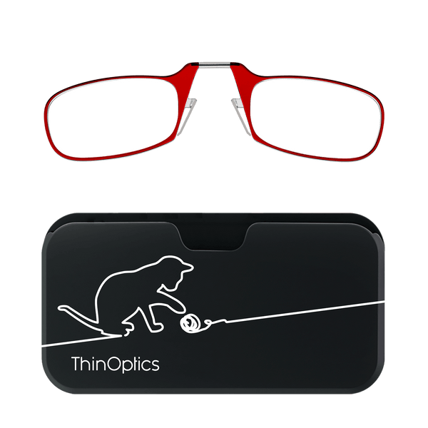 Red ThinOptics reading glasses rest on their sleek black case featuring a minimalist cat playing with yarn.