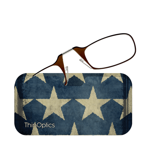 Brown reading glasses rest on a blue and beige star-patterned ThinOptics case.
