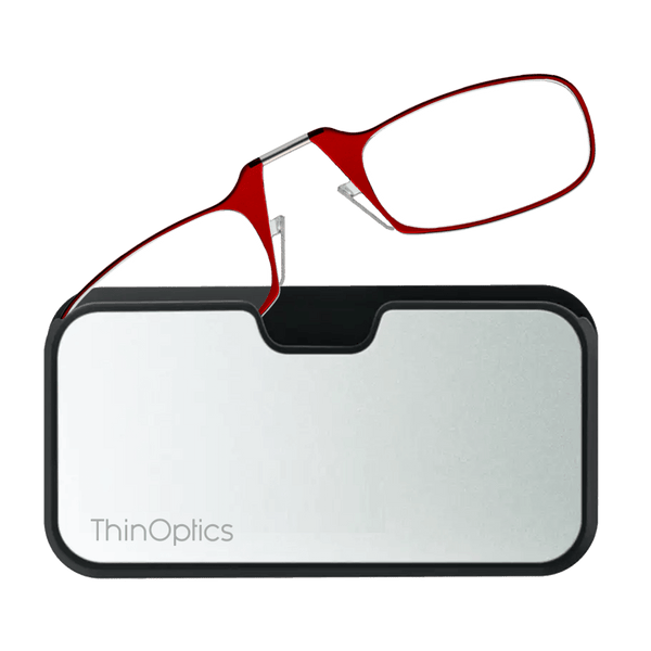Red ThinOptics reading glasses rest unfolded atop their sleek, silver case.