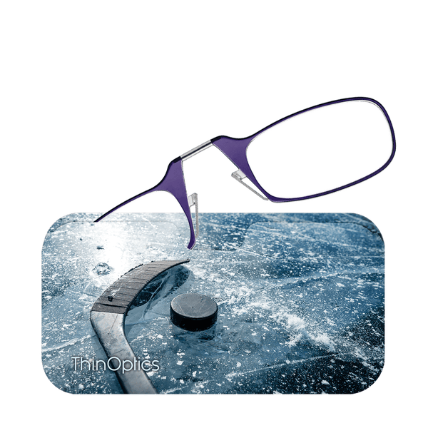 Purple ThinOptics reading glasses hover above a photo of a hockey puck and stick on an icy surface.