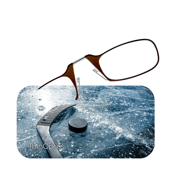 Brown ThinOptics reading glasses hover above an image of a hockey puck and stick on a textured ice rink.