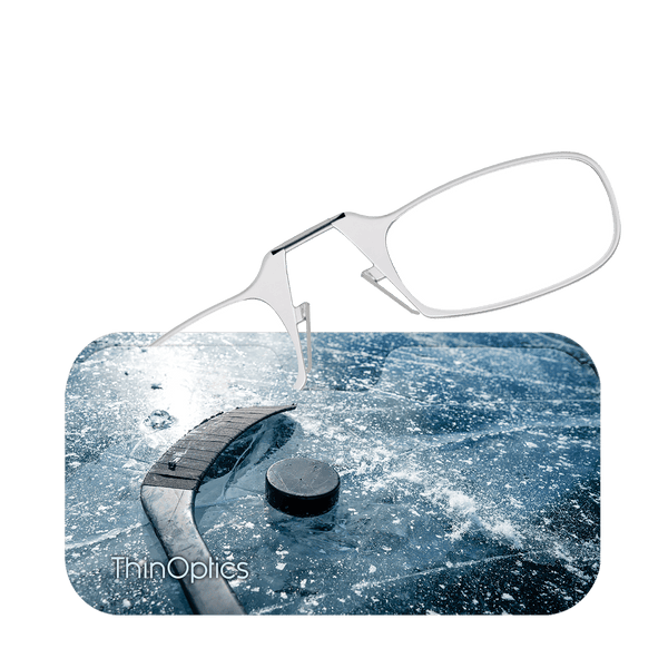 ThinOptics reading glasses rest above an image of a hockey puck and stick on a frozen pond.