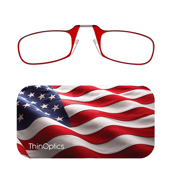 Red ThinOptics reading glasses folded atop a patriotic American flag case.